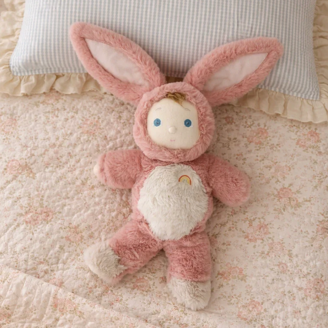 Pink plush toy with bunny ears on a textured surface