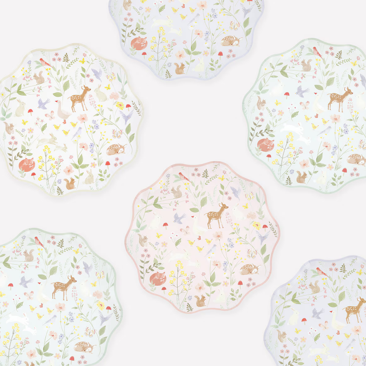 Set of decorative plates with animal and floral patterns on a white background
