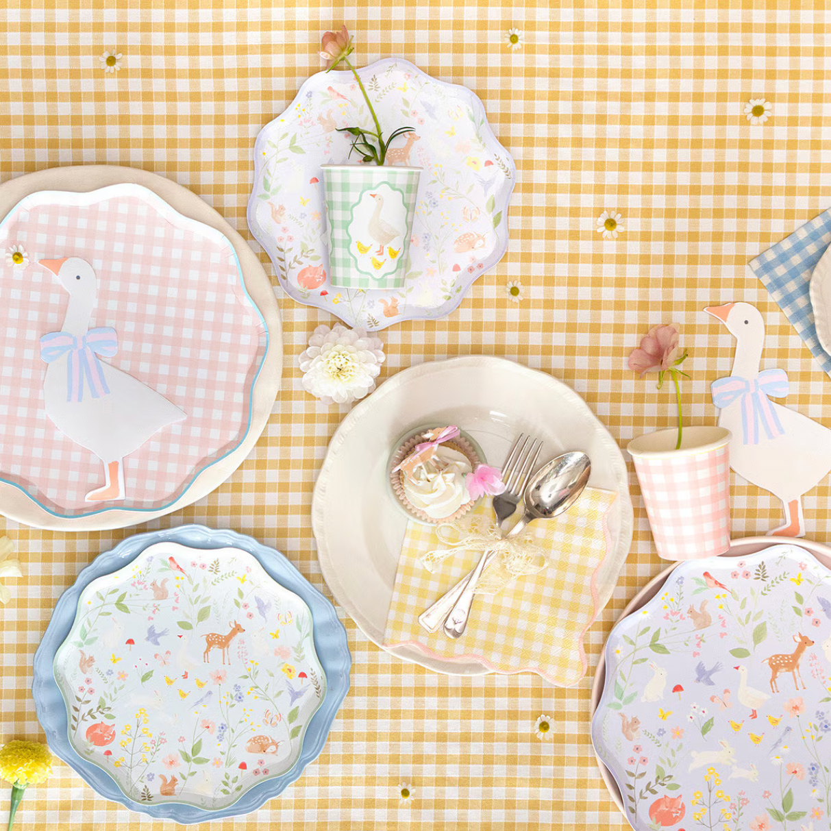 Set of decorative plates with animal prints on a yellow checkered tablecloth.
