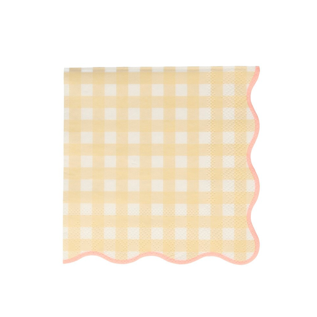 Yellow and white checkered fabric with scalloped edge on a light pink background