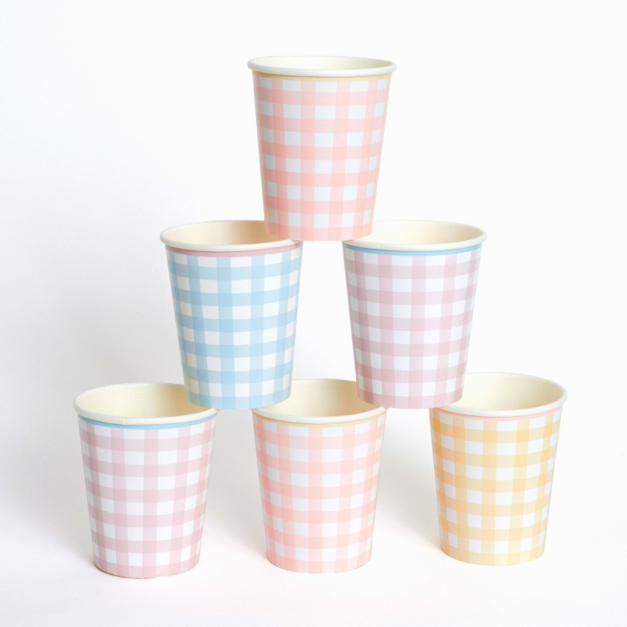 Set of six paper cups with pink, blue, and yellow checkered patterns on a white background.