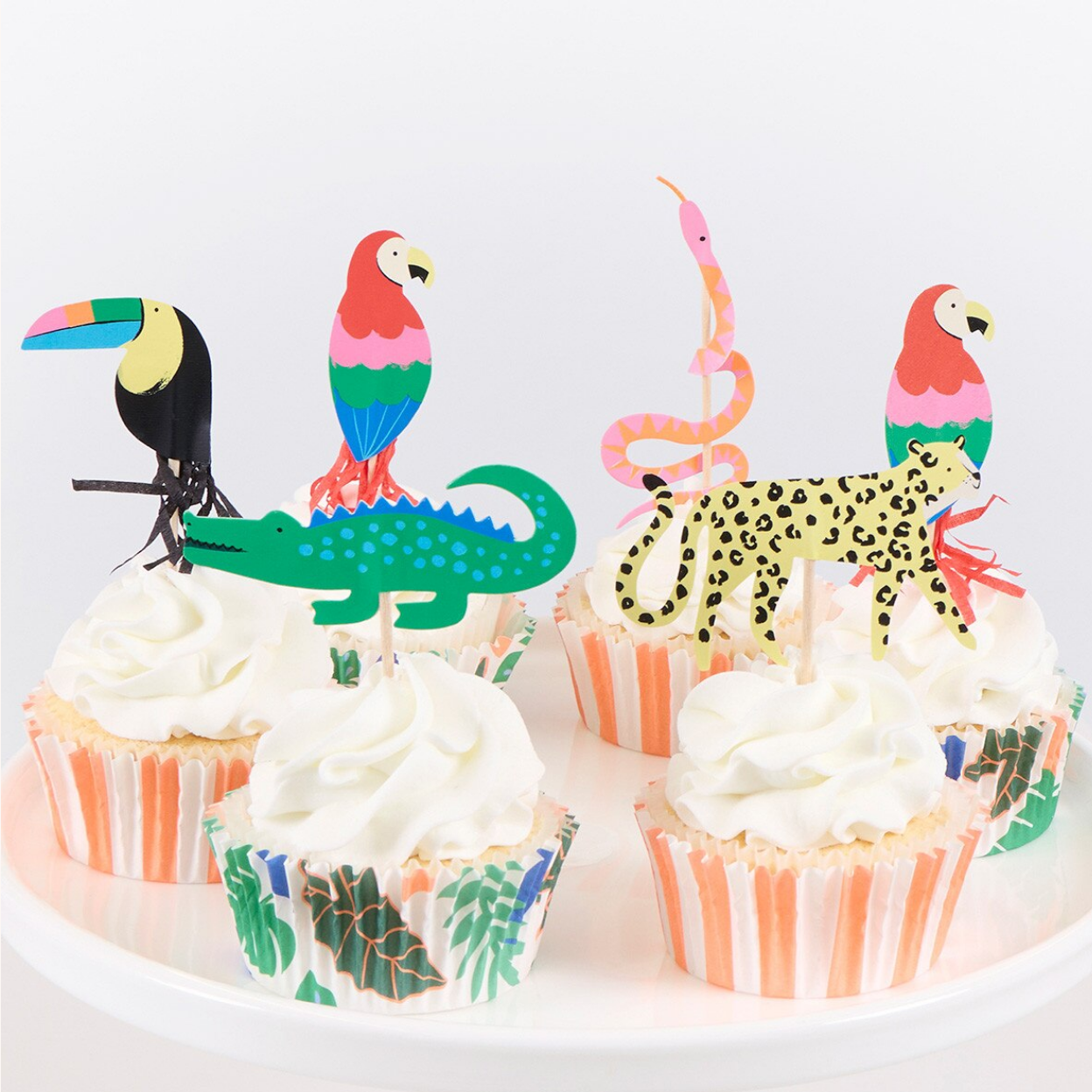 Cupcakes with animal-themed toppers on a white background