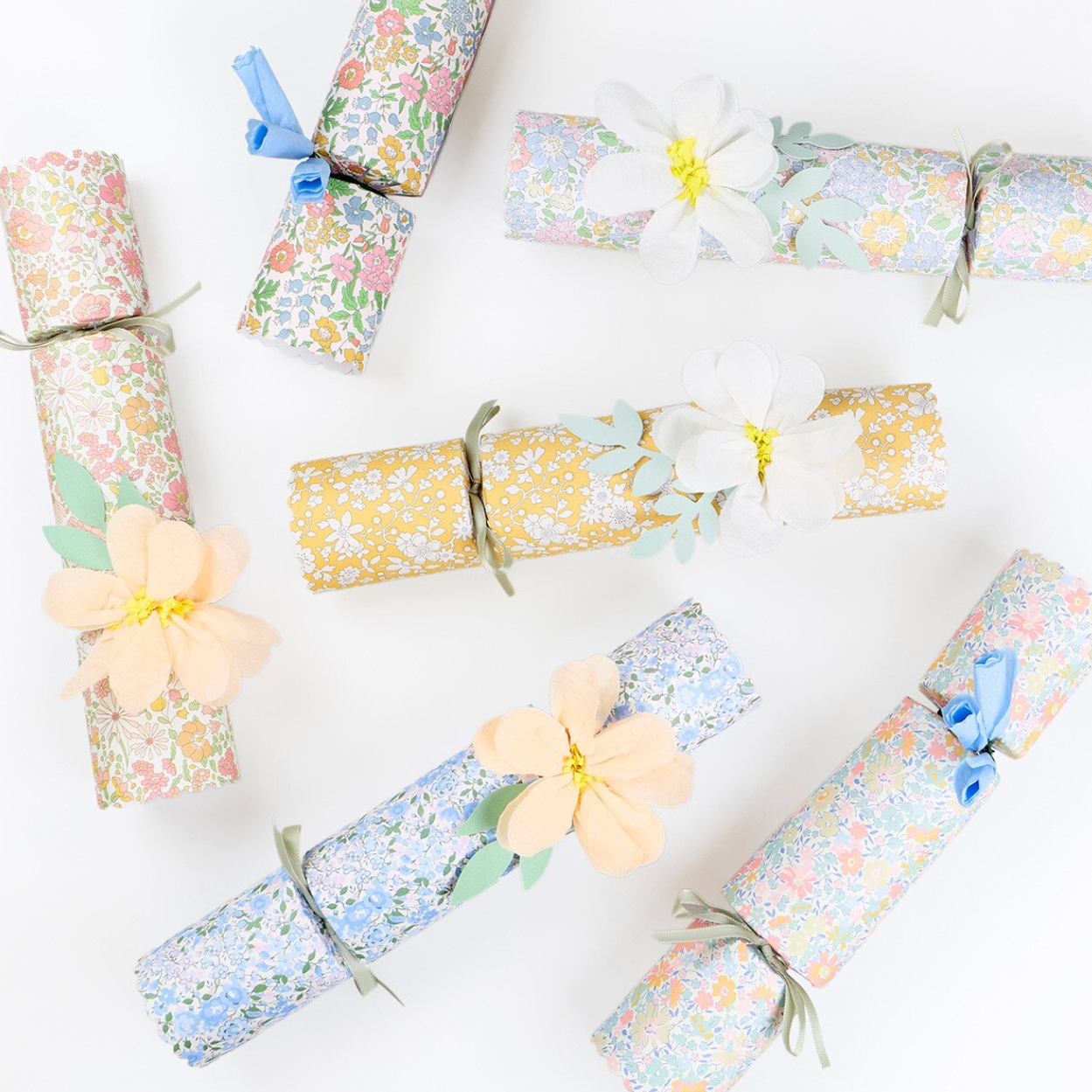Decorative cracker rolls with floral designs on a white background