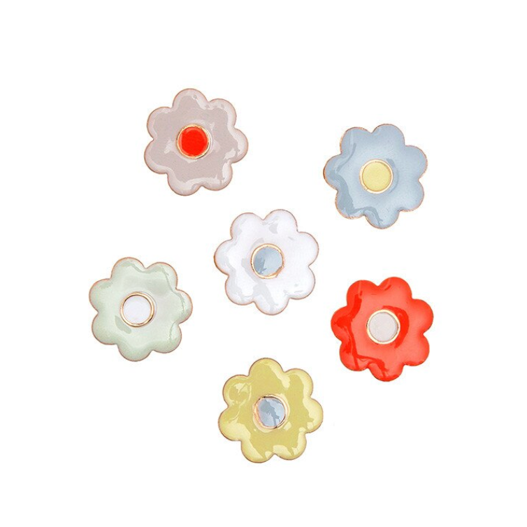 Set of colorful flower-shaped buttons on a white background