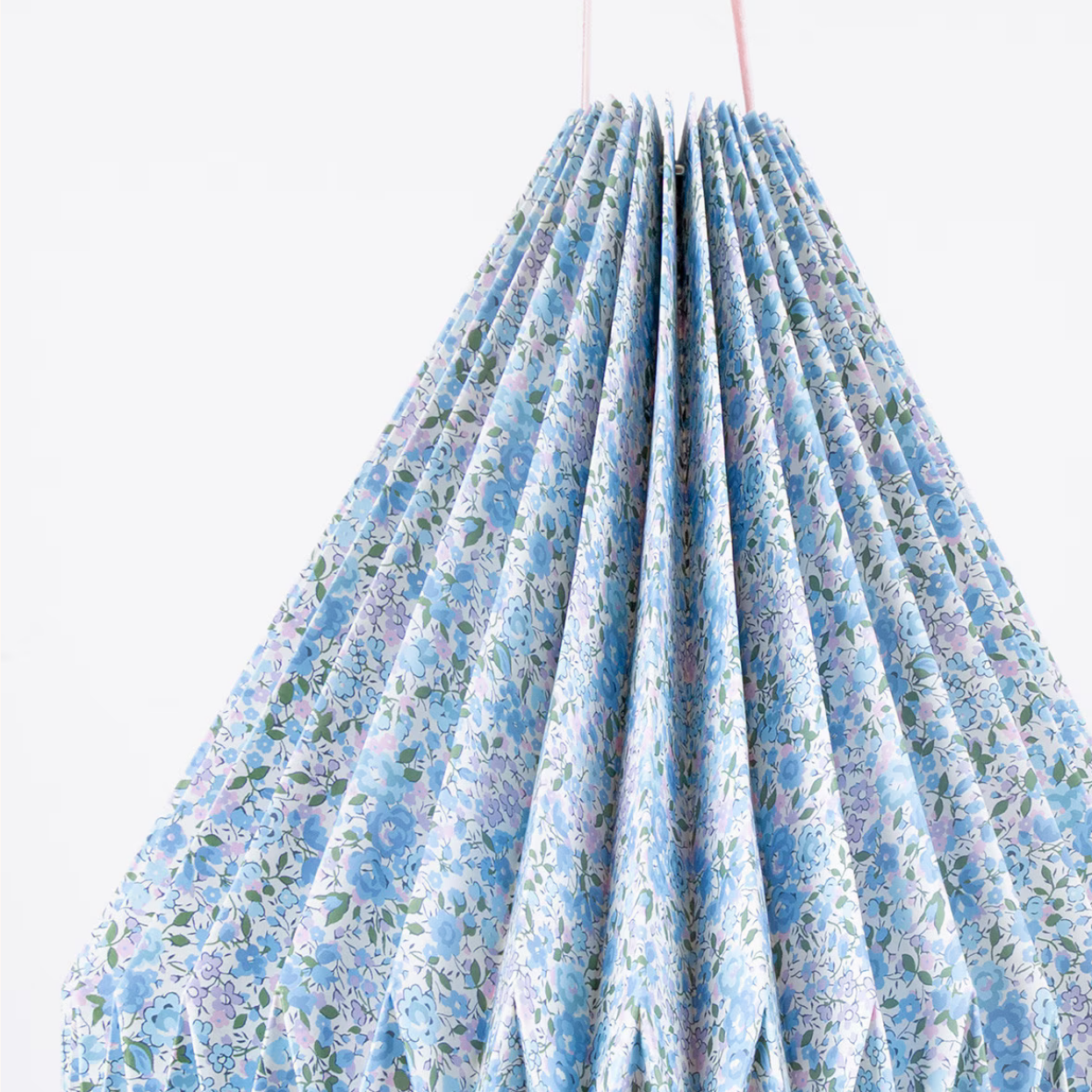 Floral-patterned fabric hanging against a white background