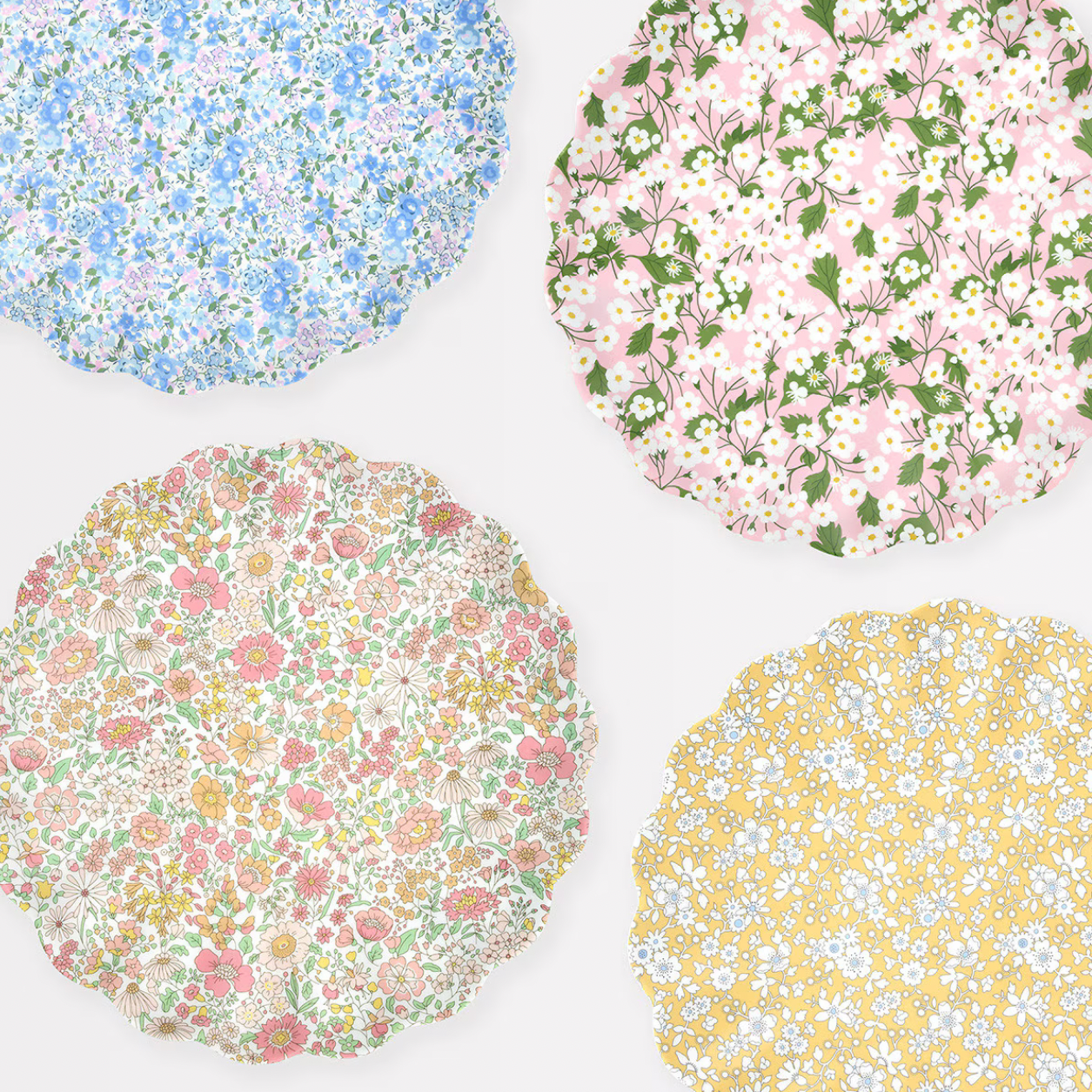Four floral-patterned coasters on a white background