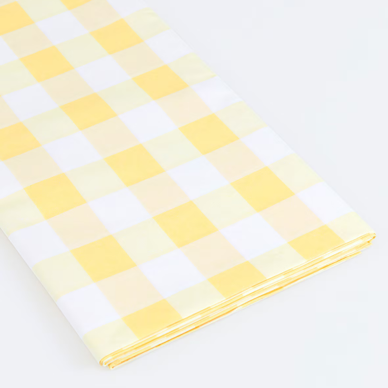 Yellow and white checkered fabric on a light gray background