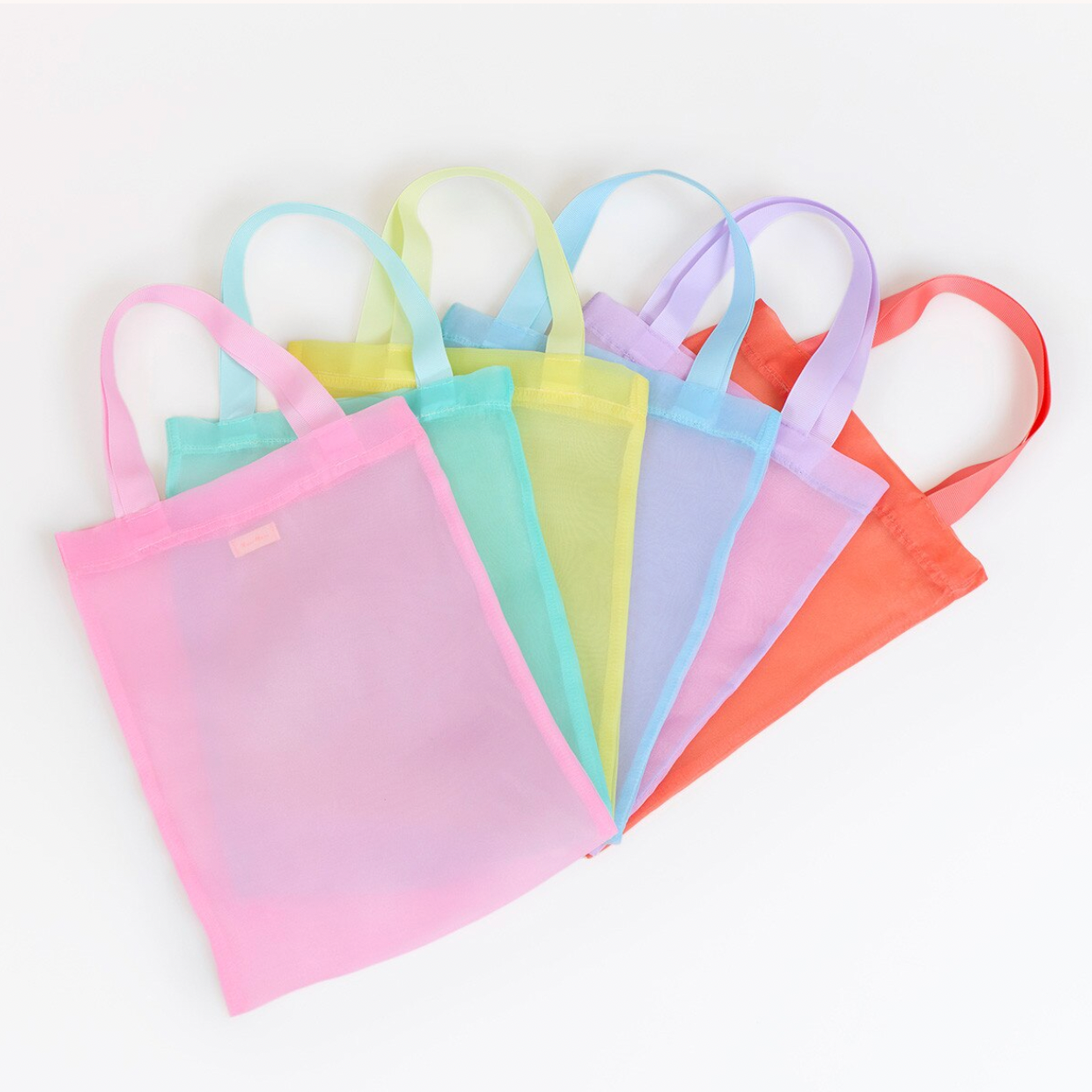 Set of colorful gradient tote bags on a white background