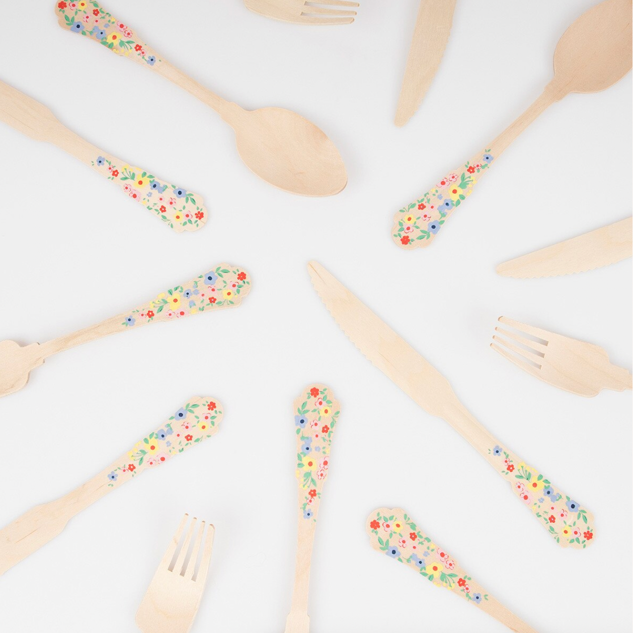 Wooden utensils with colorful handles on a white background