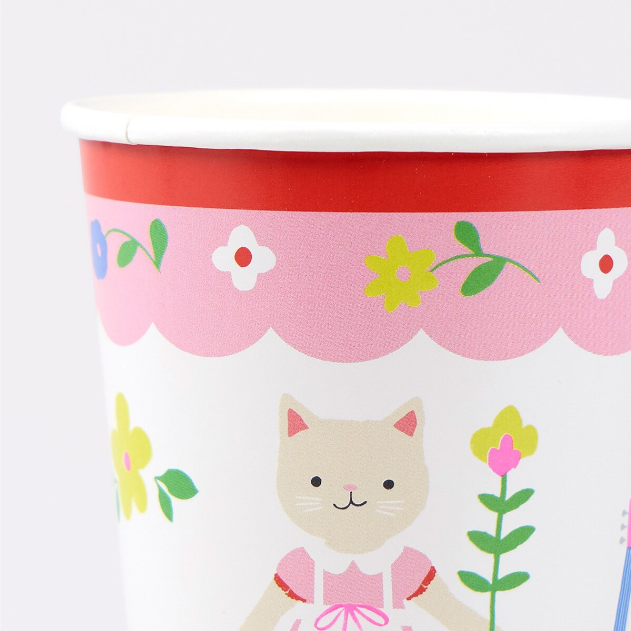 Children's paper cup with a cat and floral design on a white background
