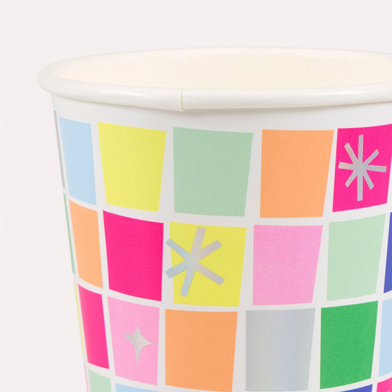 Colorful paper cup with a pattern of squares and stars on a white background
