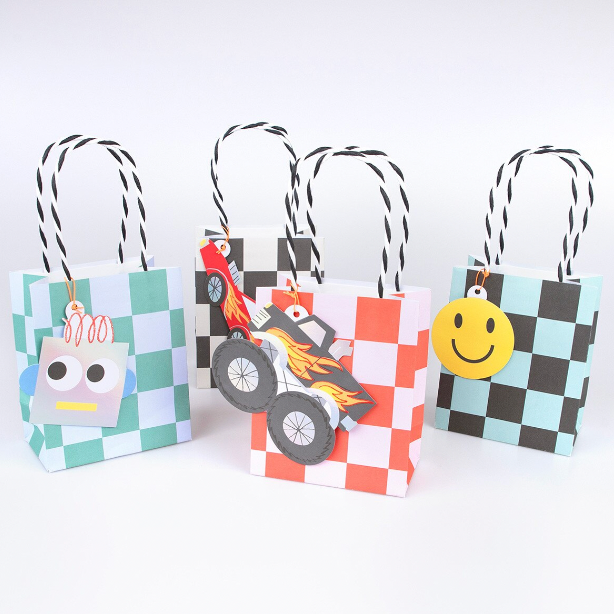 Three colorful paper bags with decorative elements on a white background