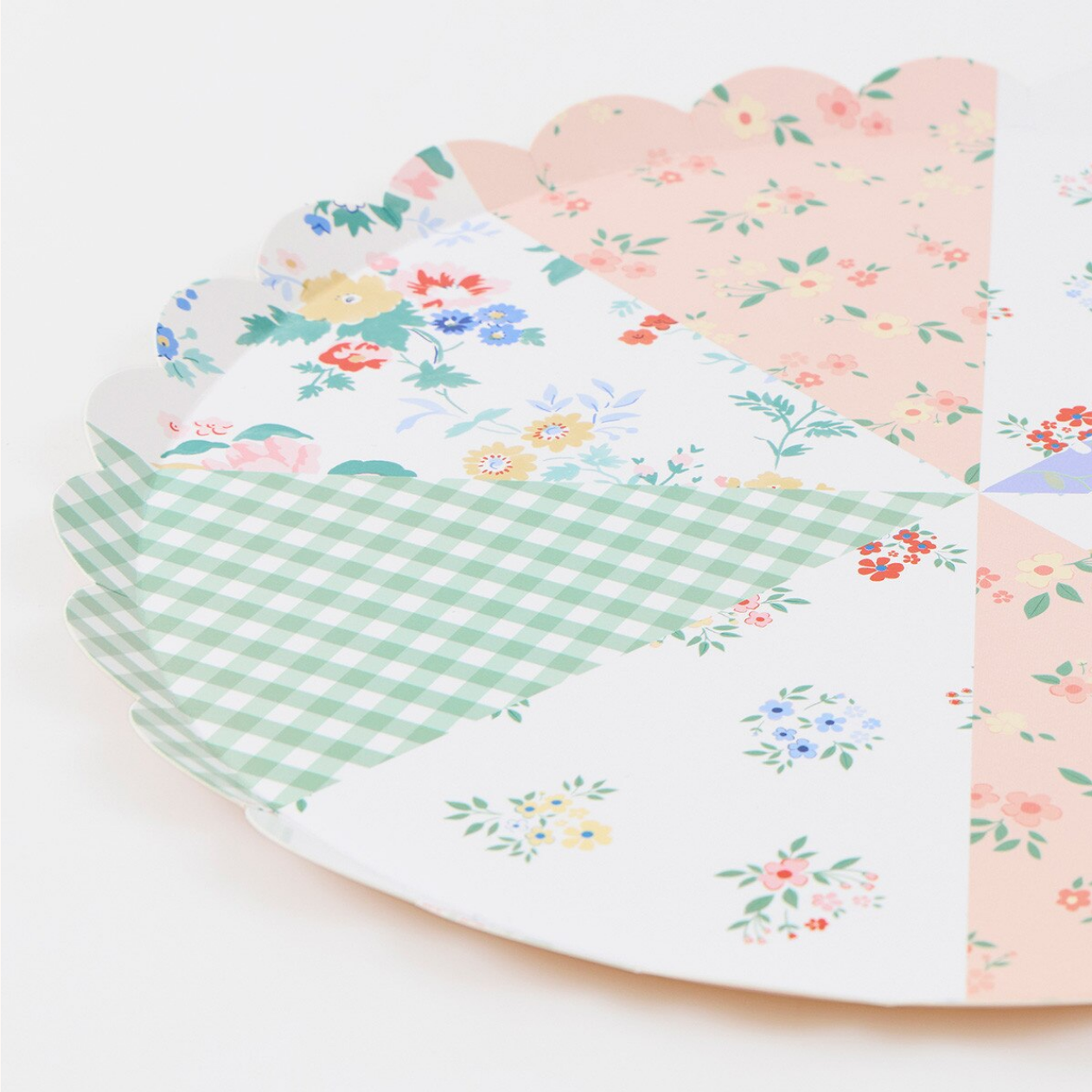 Set of floral and checkered paper plates on a white background