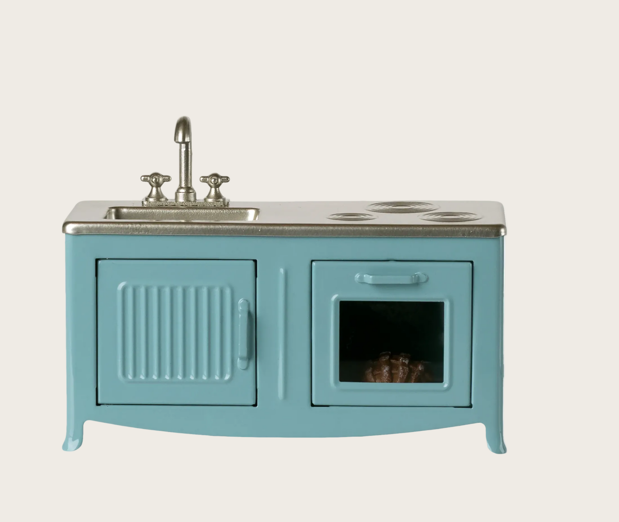 Blue kitchen cabinet with sink and stove top 