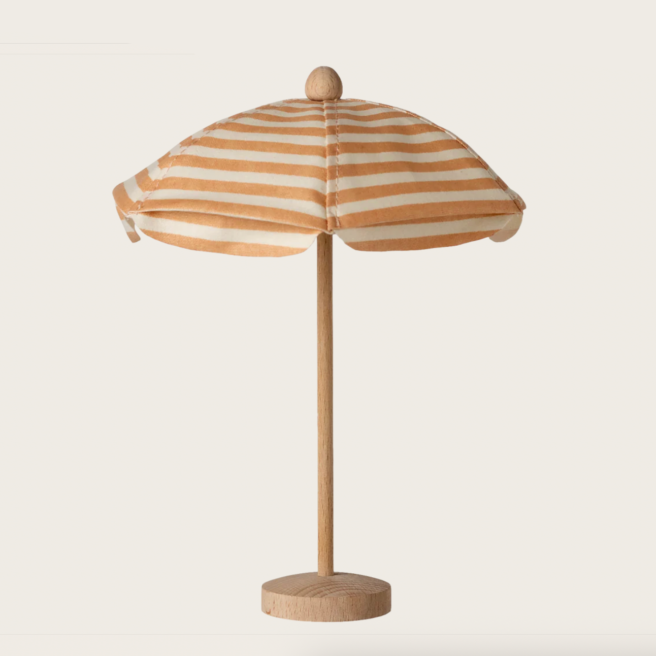 Striped umbrella on a stand with 'maileg' branding