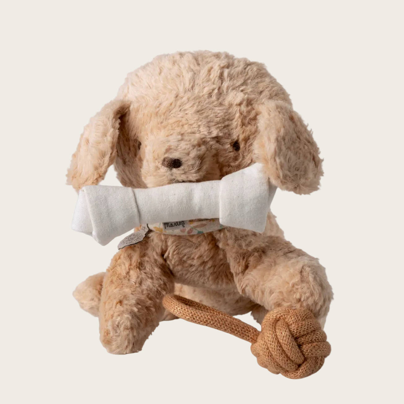 Beige plush dog toy with a bone on a website page