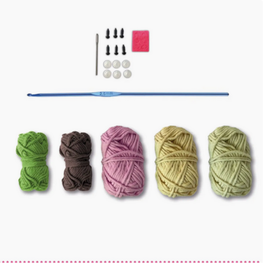 Crochet kit with yarn balls and tools on a white background