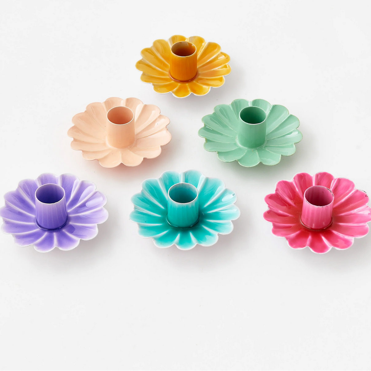 Set of colorful metal candle holders on a white background