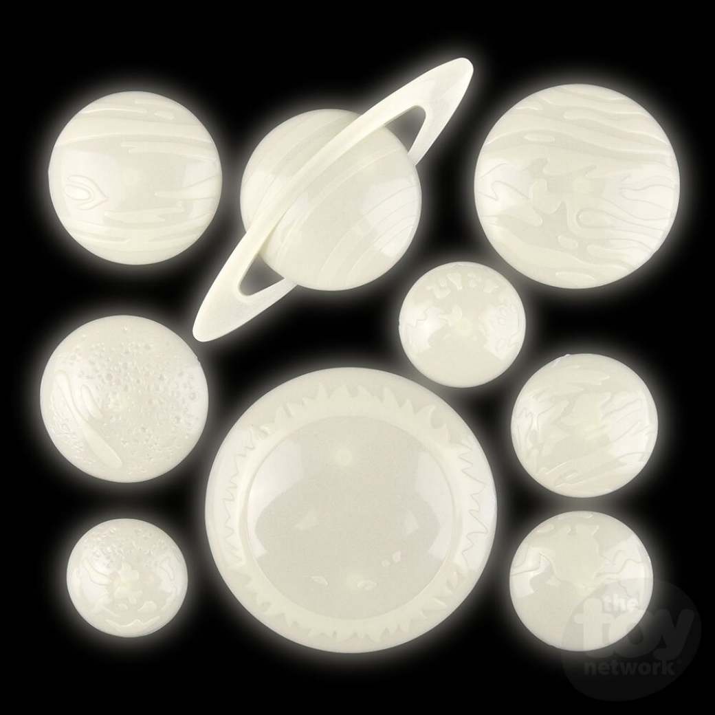 Set of glow-in-the-dark planet models on a black background