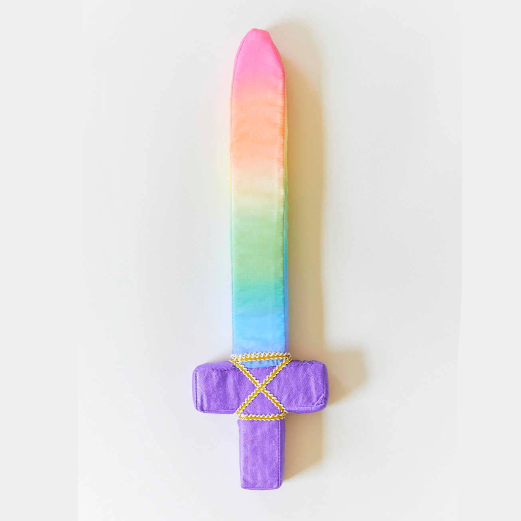 Colorful toy sword on a white background with a cream in the background.