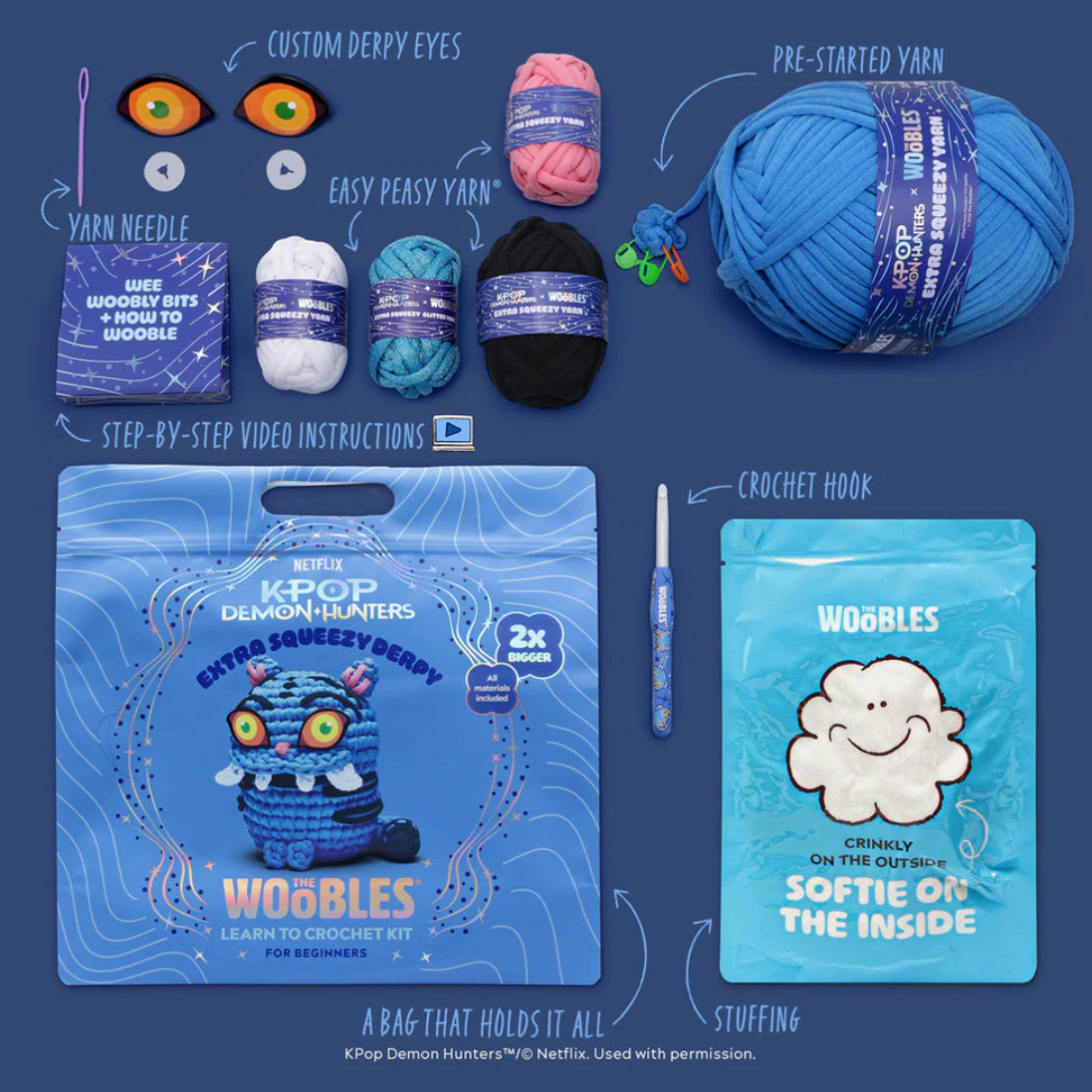 Wobbles toy kit with yarn, crochet hook, and packaging on a blue background