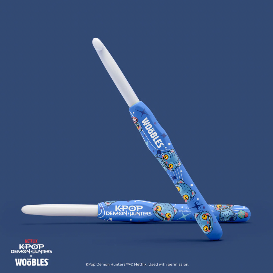 Blue and white toy swords with 'K-POP Demon Hunters' branding on a navy background
