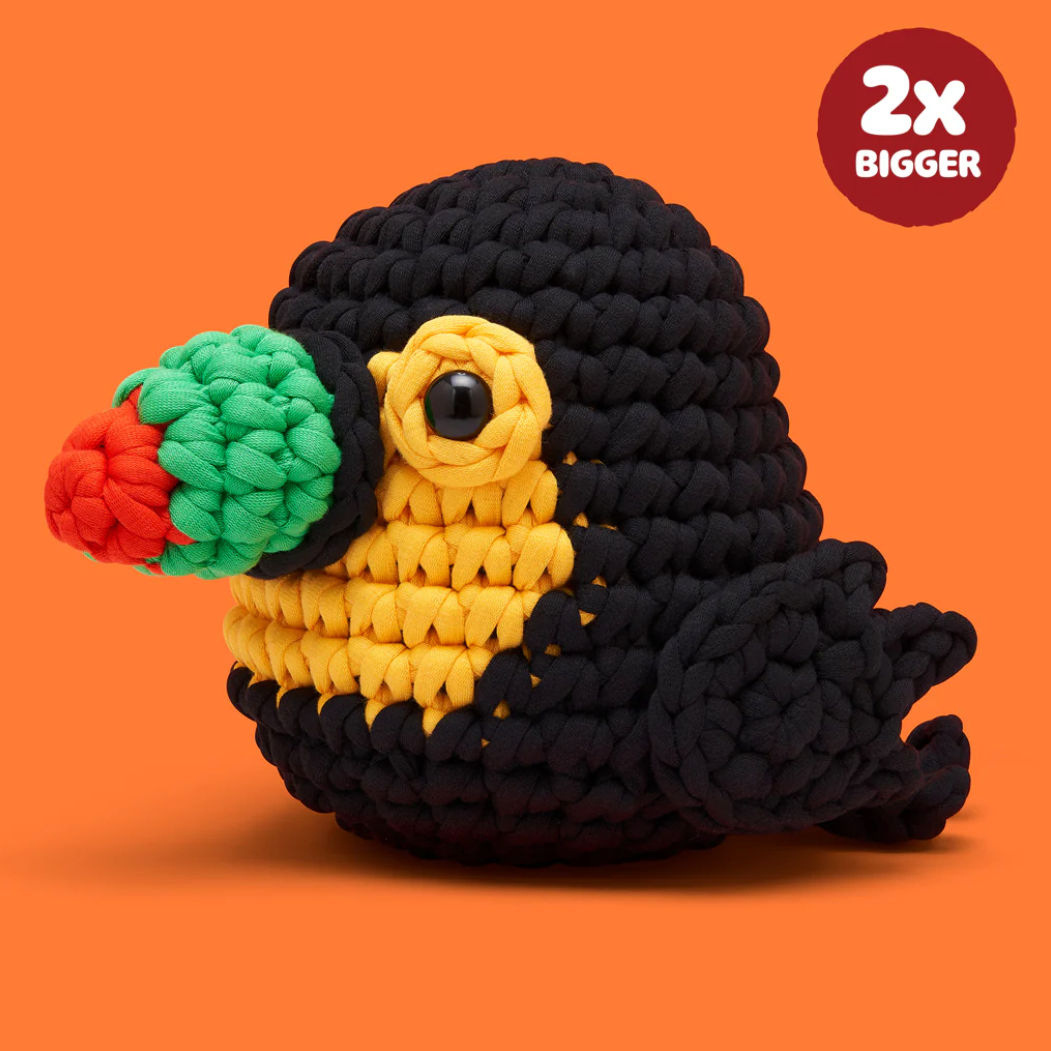 Crocheted parrot toy on an orange background with promotional text.
