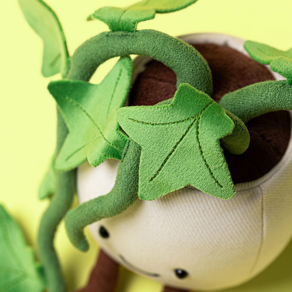 Plush toy with green leafy design on a yellow background