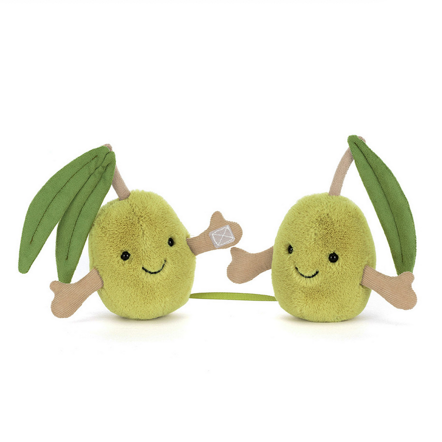 Two plush olives with smiling faces and leafy branches on a white background