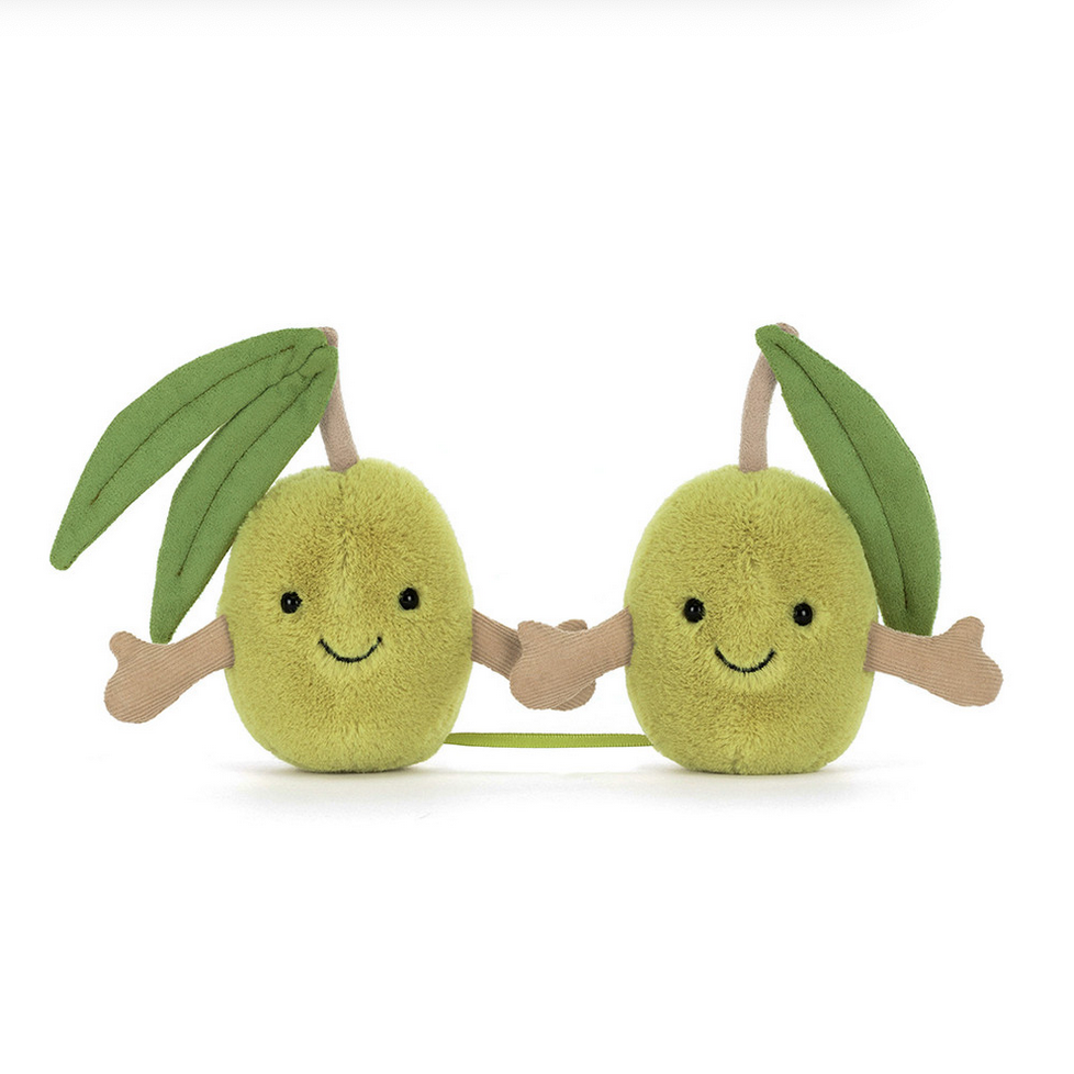 Two plush avocado toys with smiling faces on a white background