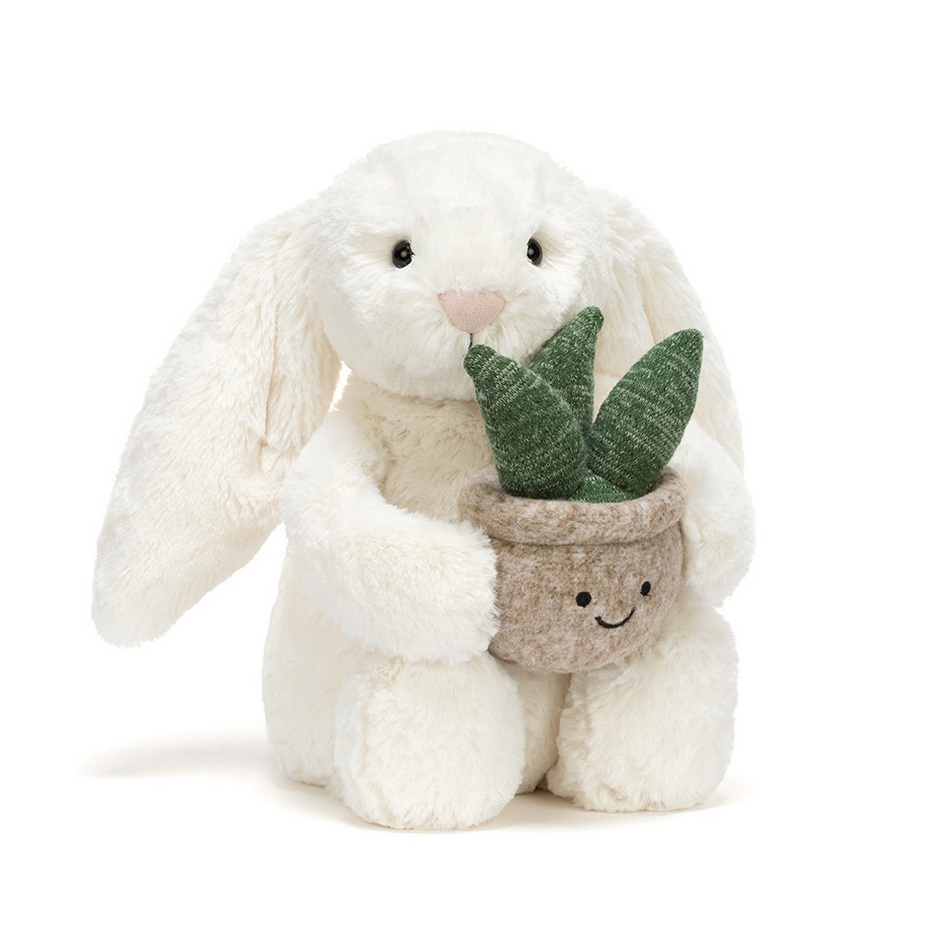 Stuffed bunny holding a potted plant on a white background