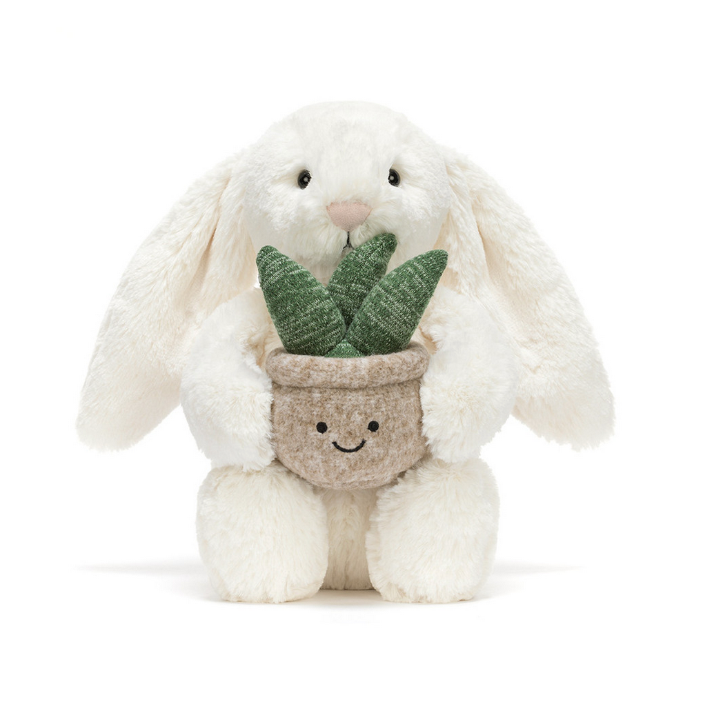 White plush bunny holding a potted plant on a white background