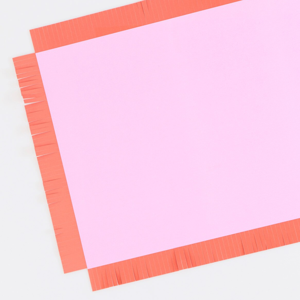 Pink paper with a red border on a white background