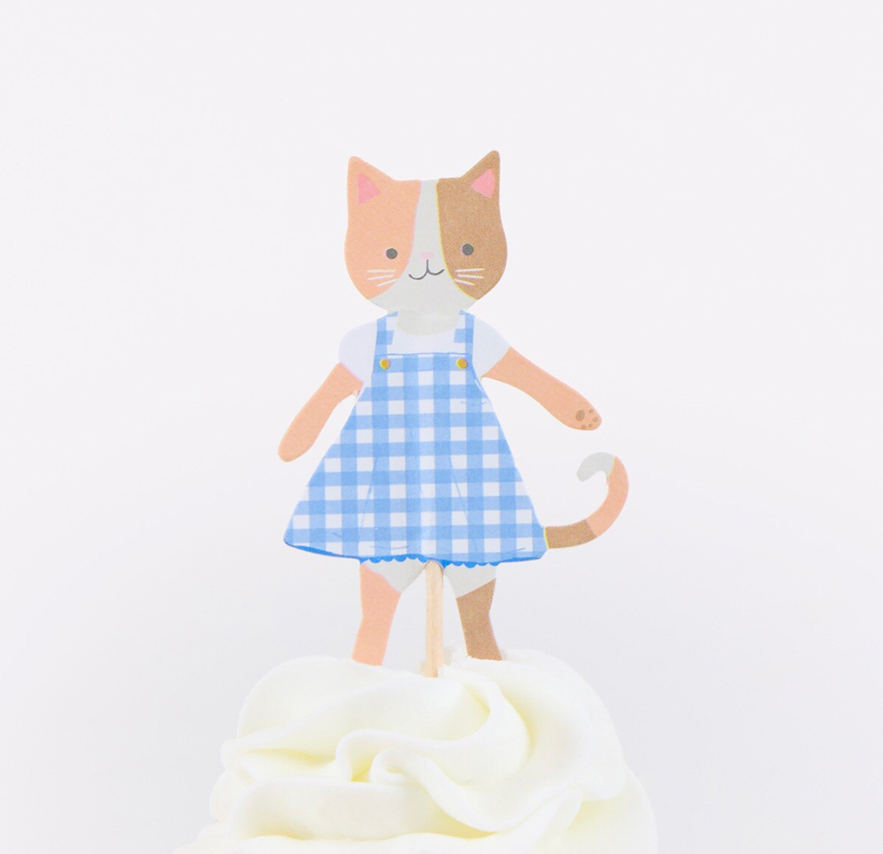 Cat-shaped toy with a blue checkered dress on a white background