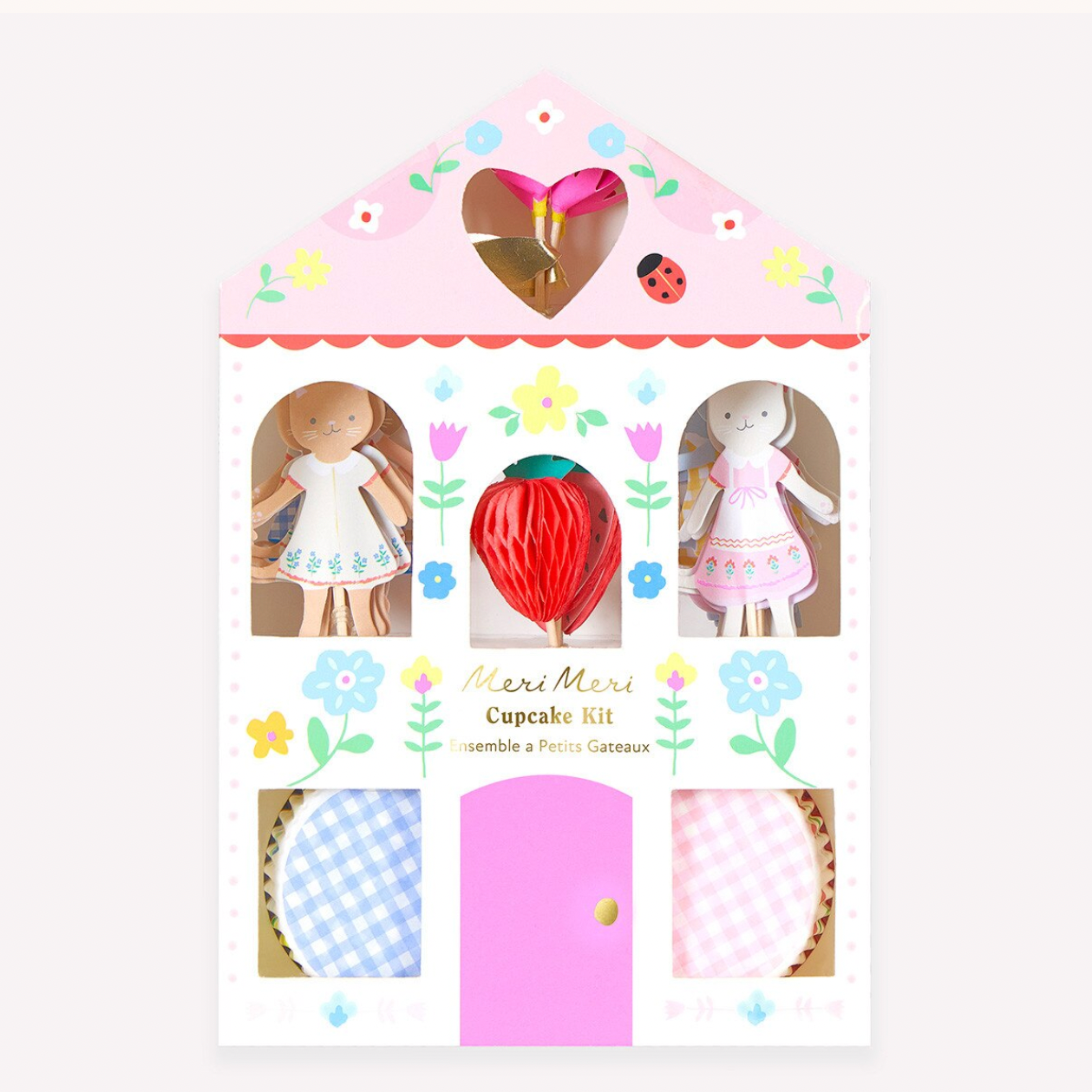 Cupcake kit packaging with illustrations of dolls and decorative elements on a white background