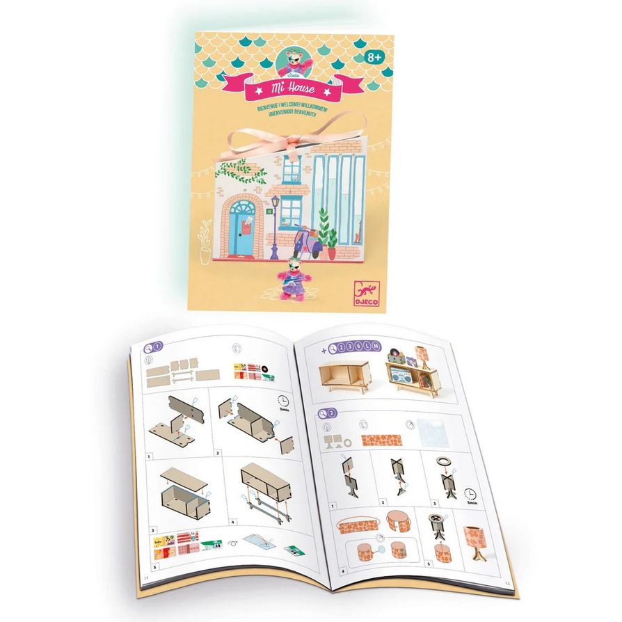 Children's activity book with illustrated house and furniture pieces on a white background