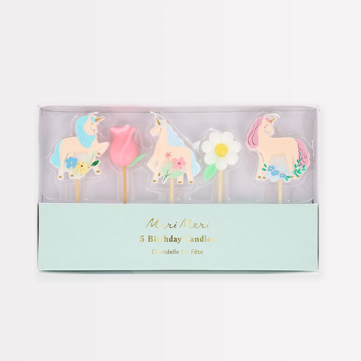 Set of unicorn-themed birthday candles in a box on a white background