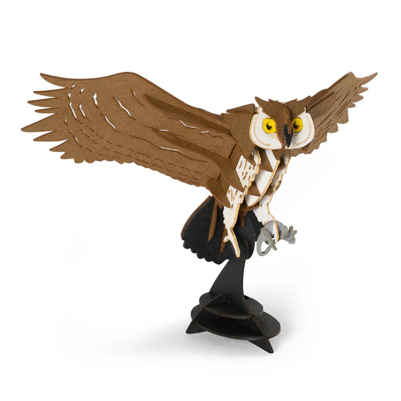 Toy owl figurine with open wings on a white background
