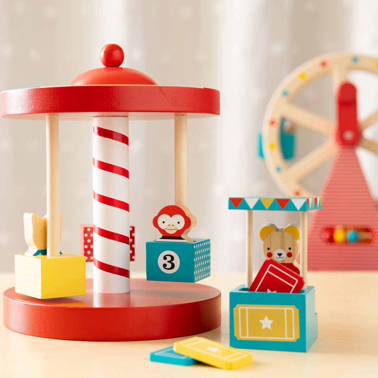 Children's toy carousel with colorful figures on a light background
