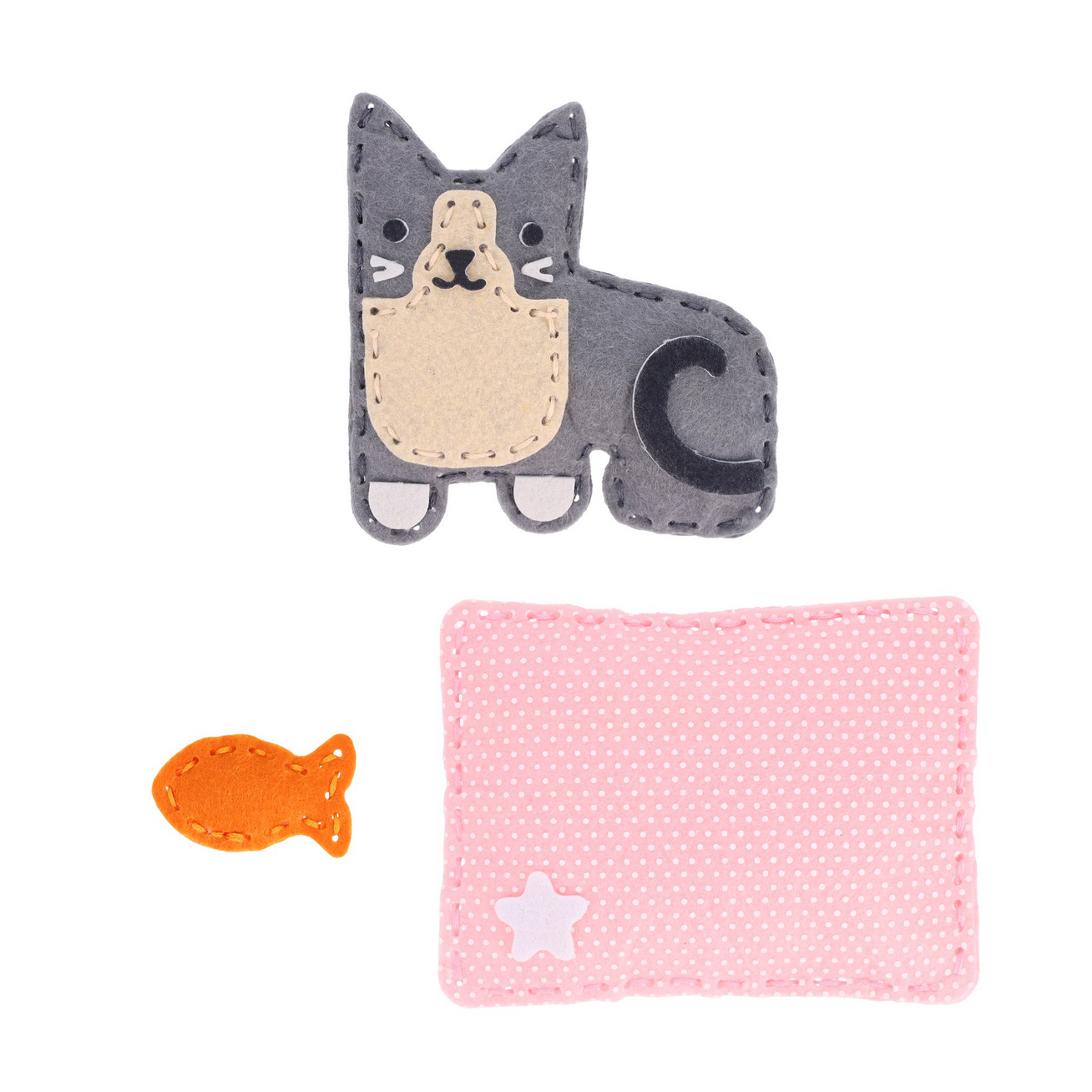 Cat-shaped fabric item, orange fish, and pink square with white star on a white background