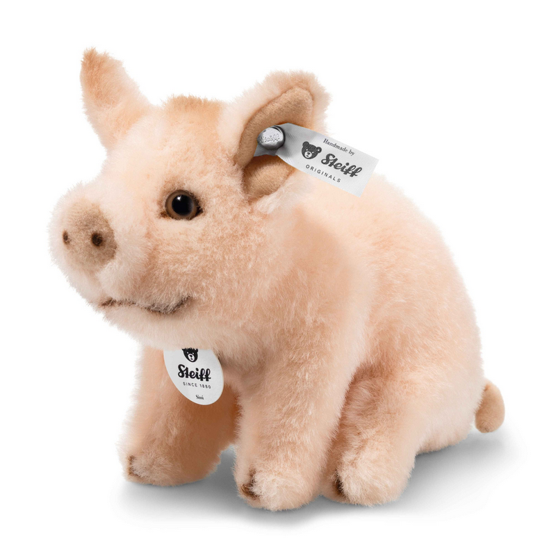 Plush pig toy with Stuffed Animals & More tag on a white background