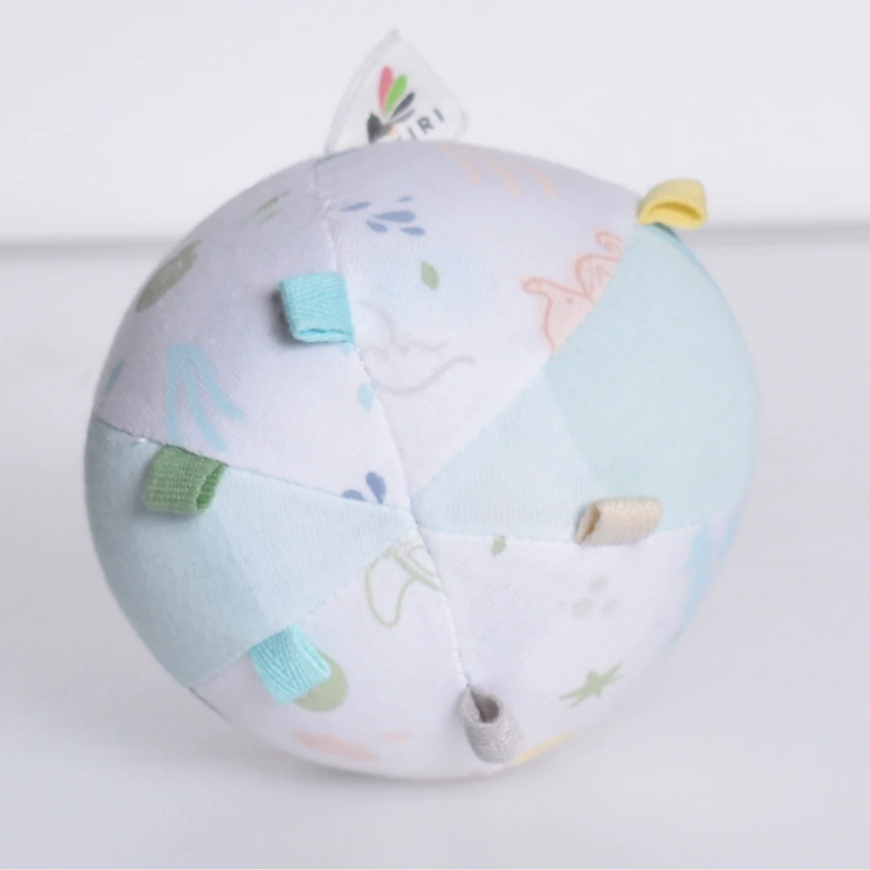 Round baby toy with colorful accents on a white background