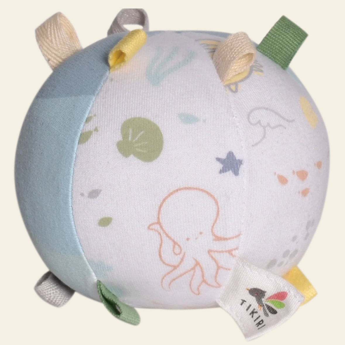 Round soft toy with ocean-themed design and Tikkaboo tag on a light background