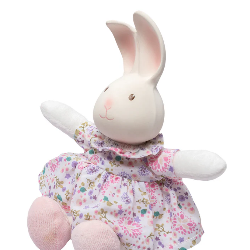 Plush rabbit toy with a floral dress on a white background