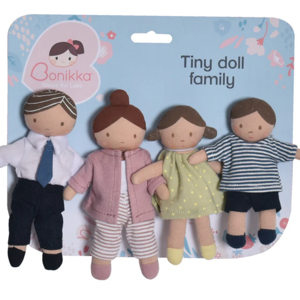 Set of four small dolls in various outfits on a blue packaging.