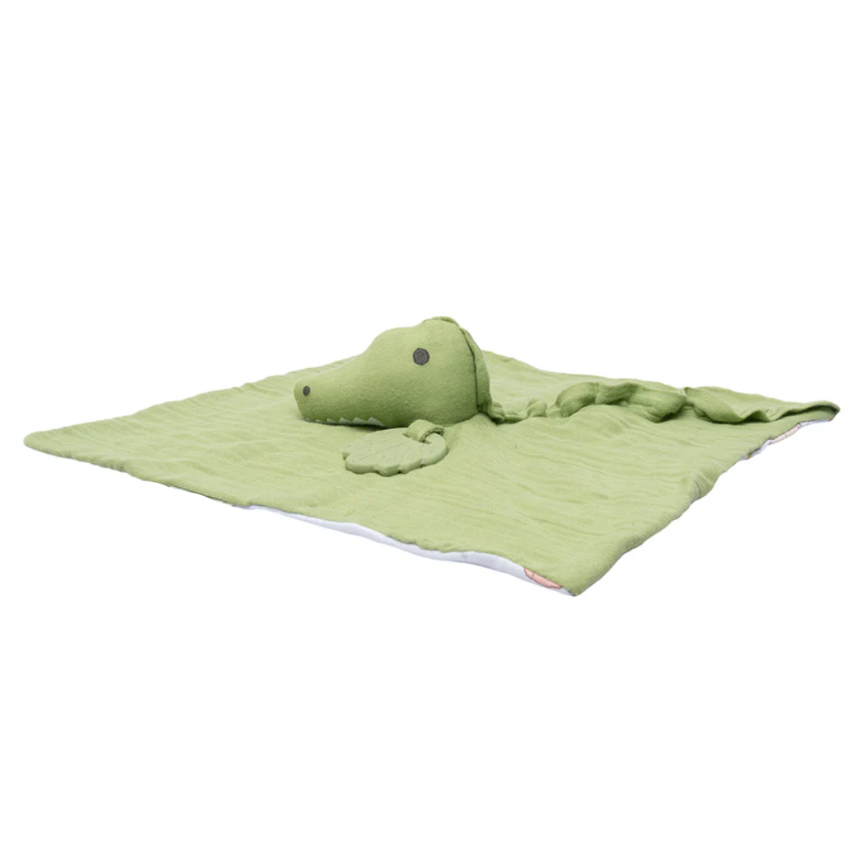 Green crocodile-shaped soft toy on a white background