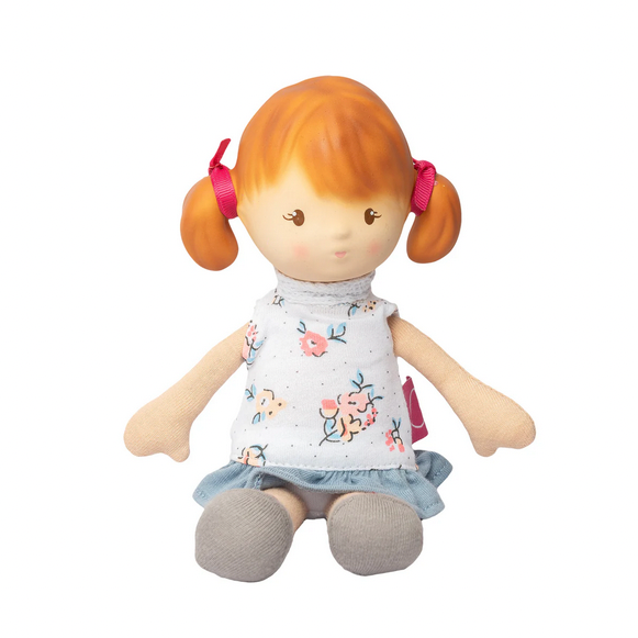 Toy doll with red hair and a white shirt on a white background