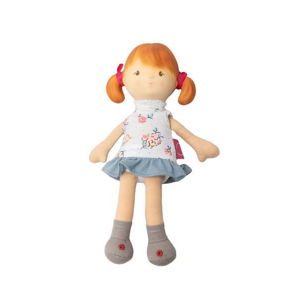 Toy doll with red hair, floral dress, and gray shoes on a white background