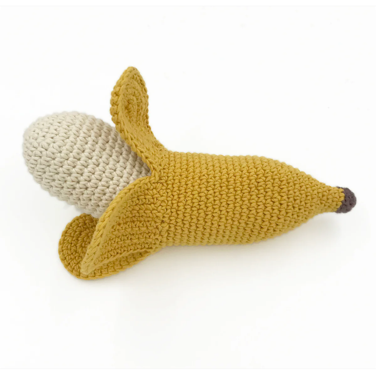 Knitted banana-shaped toy with beige stem on a white background