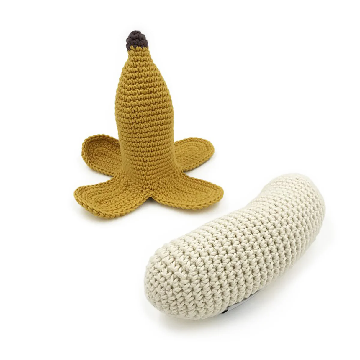 Knitted banana-shaped toy on a white background